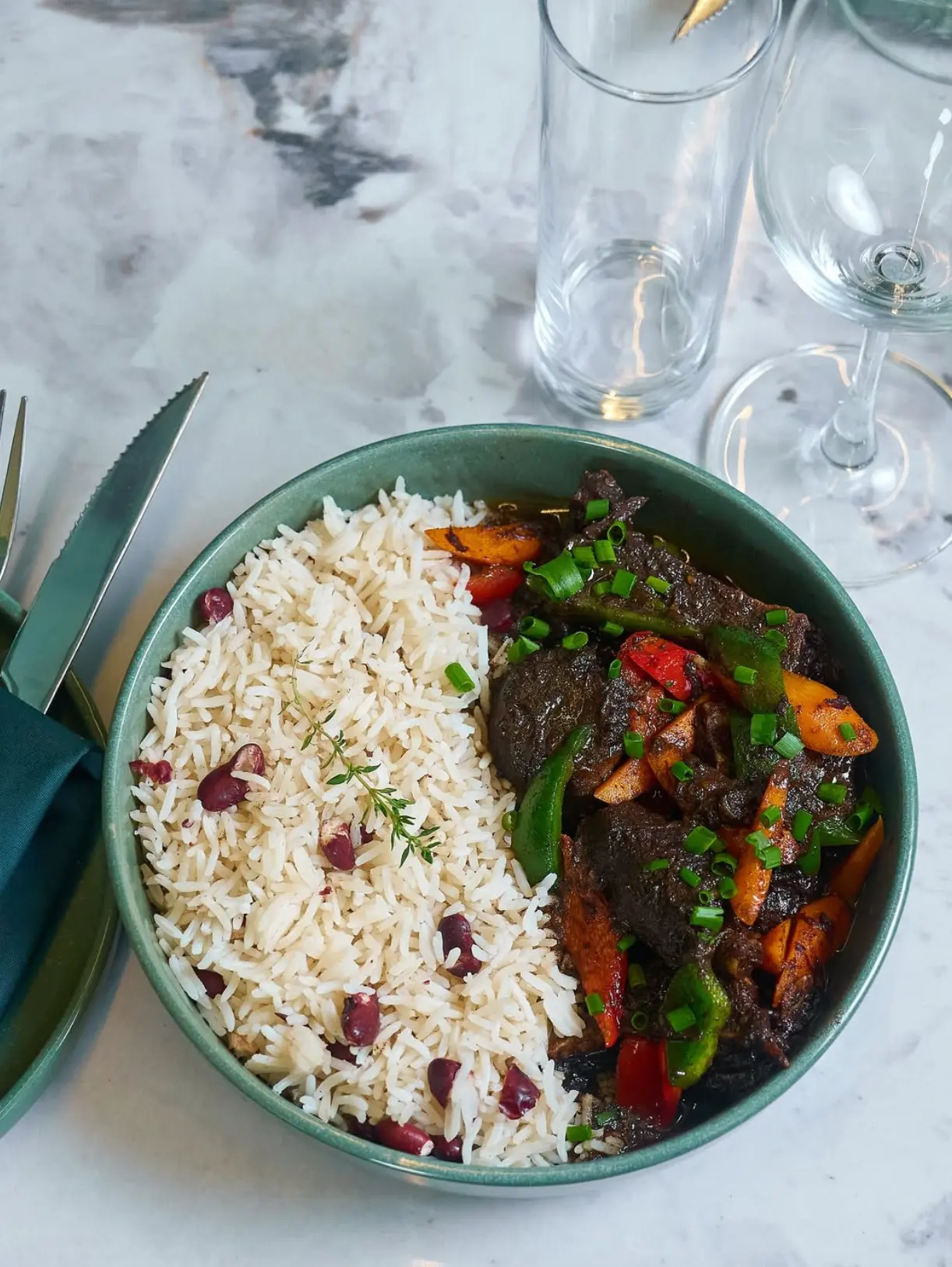 A dish from the Sidebar menu — rice, beans and slow-cooked meat served in a green bowl