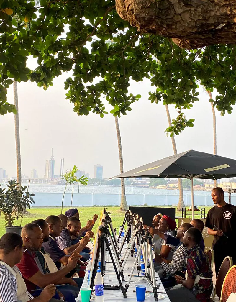 A real Sip and Paint .NG session outdoors in Lagos — guests painting at easels